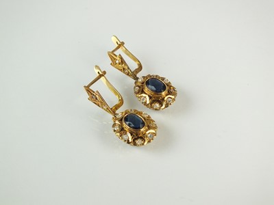 Lot 150 - A pair of diamond and blue paste earrings