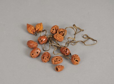 Lot 221 - An associated selection of twelve Chinese heido nut (fruit pit) carvings