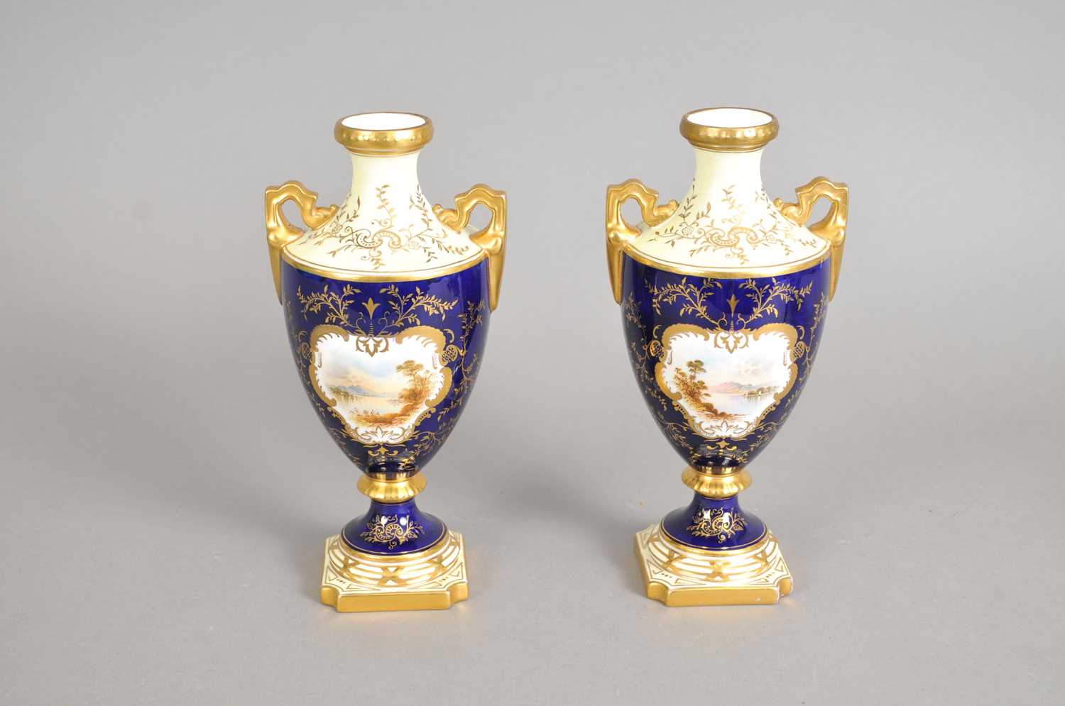 Lot 191 - A pair of Coalport twin-handled landscape vases