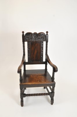 Lot 350 - A heavy carved oak arm chair in the Carolean style