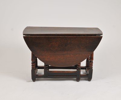 Lot 550 - A small 18th century oak gateleg dining table,...