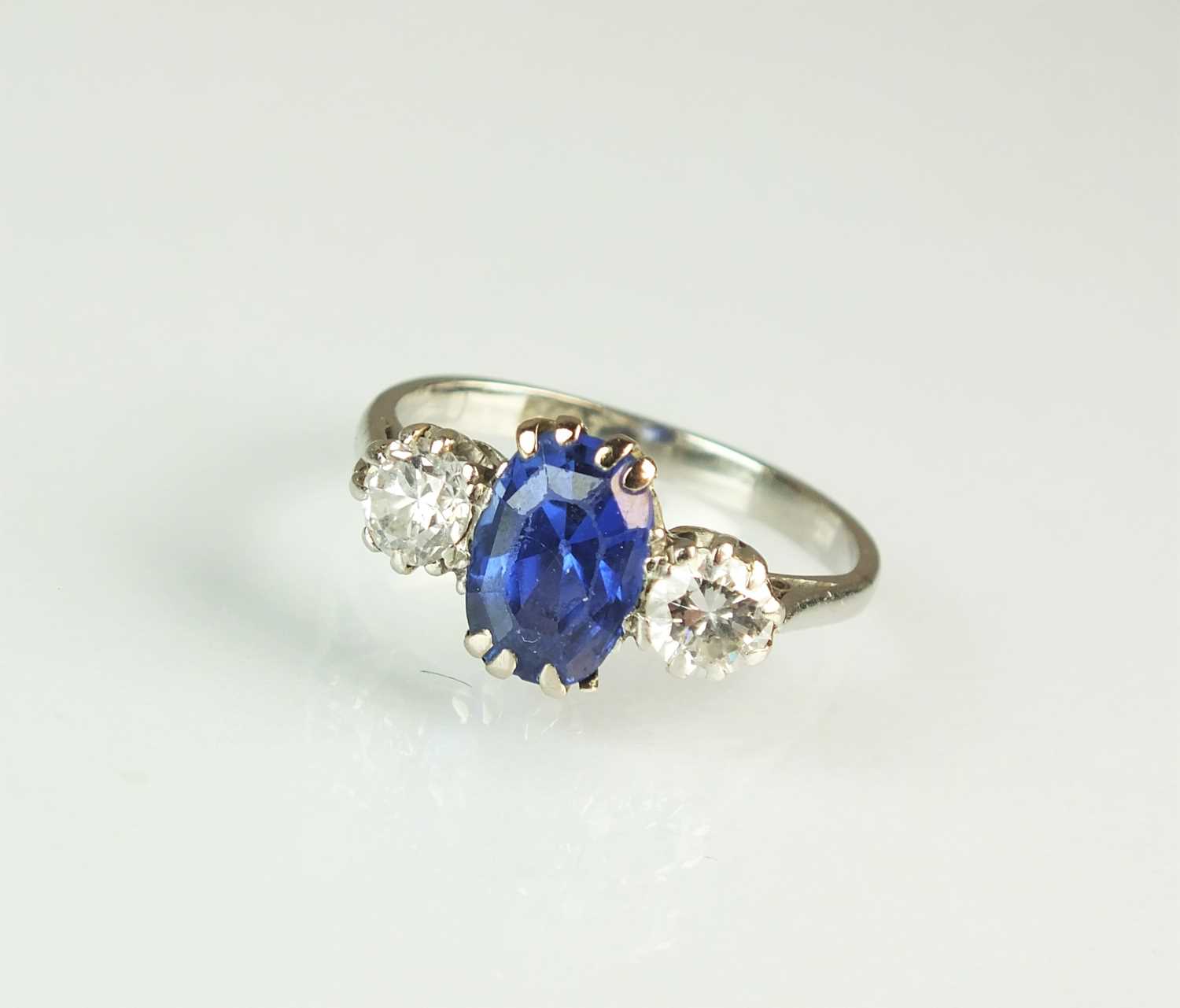 163 - A three stone sapphire and diamond ring