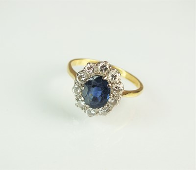 Lot 144 - An oval sapphire and diamond cluster ring