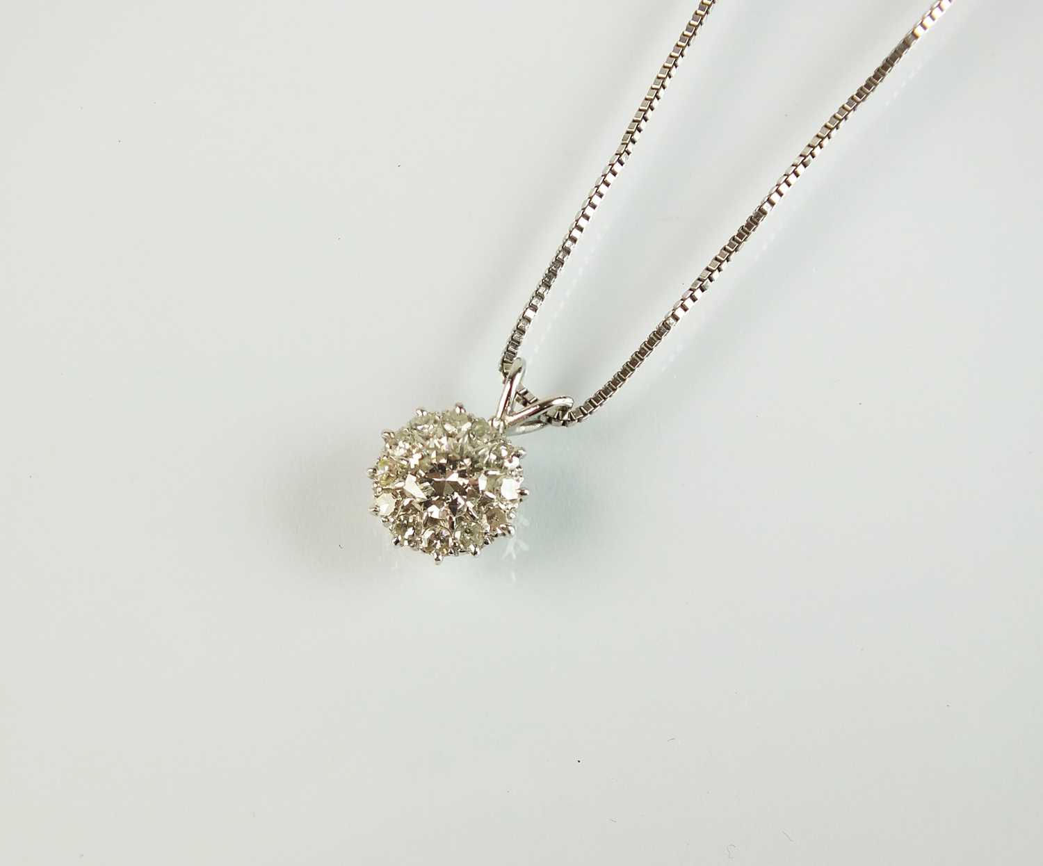 Lot 85 - A diamond cluster pendant