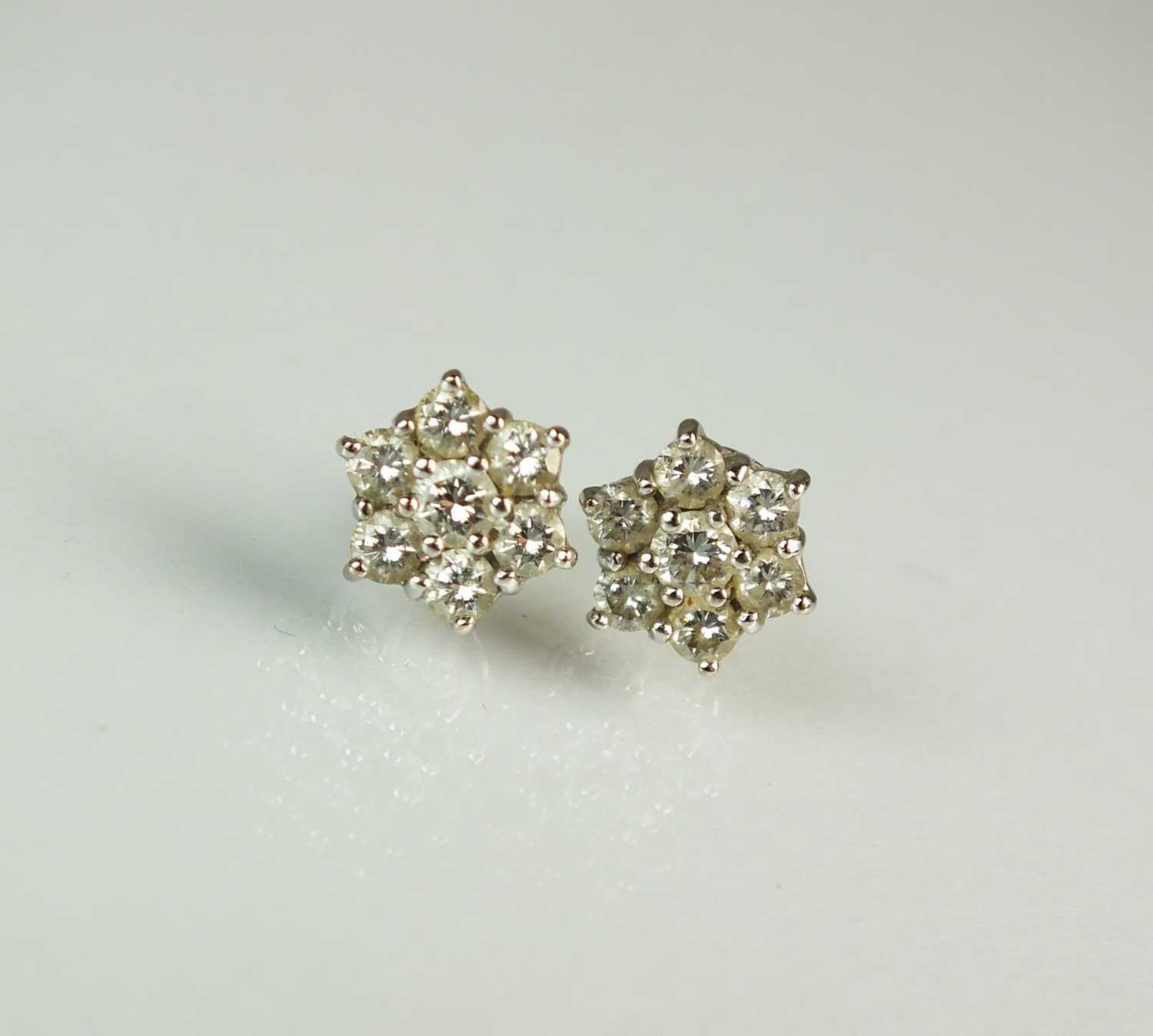 Lot 142 - A pair of diamond floral cluster earrings