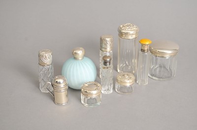 Lot 109 - A collection of nine silver topped dressing table jars