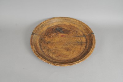 Lot 283 - A large 18th century rustic farmhouse hewn shallow bowl / charger