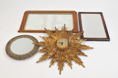 Lot 318 - An early 20th century Garrard carved gilt wood starburst framed wall clock and three wall mirrors
