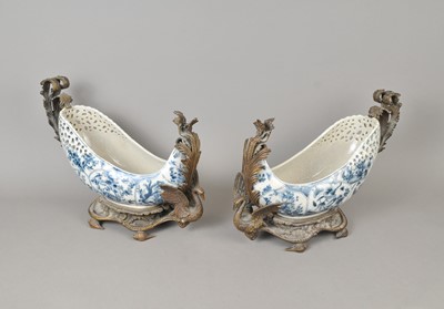 Lot 183 - A decorative pair cast of metal mounted blue and white ceramic boats