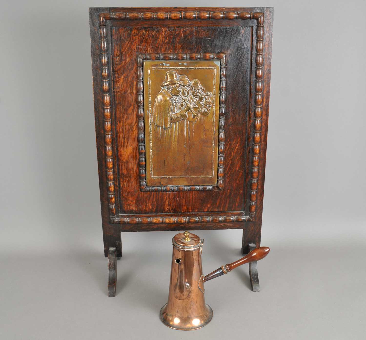 Lot 259 - An oak framed continental fire screen and a Victorian copper chocolate pot