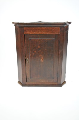 Lot 512 - A country oak corner cupboard