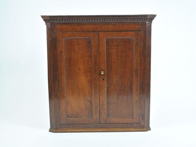 Lot 403 - A George III country oak corner cupboard