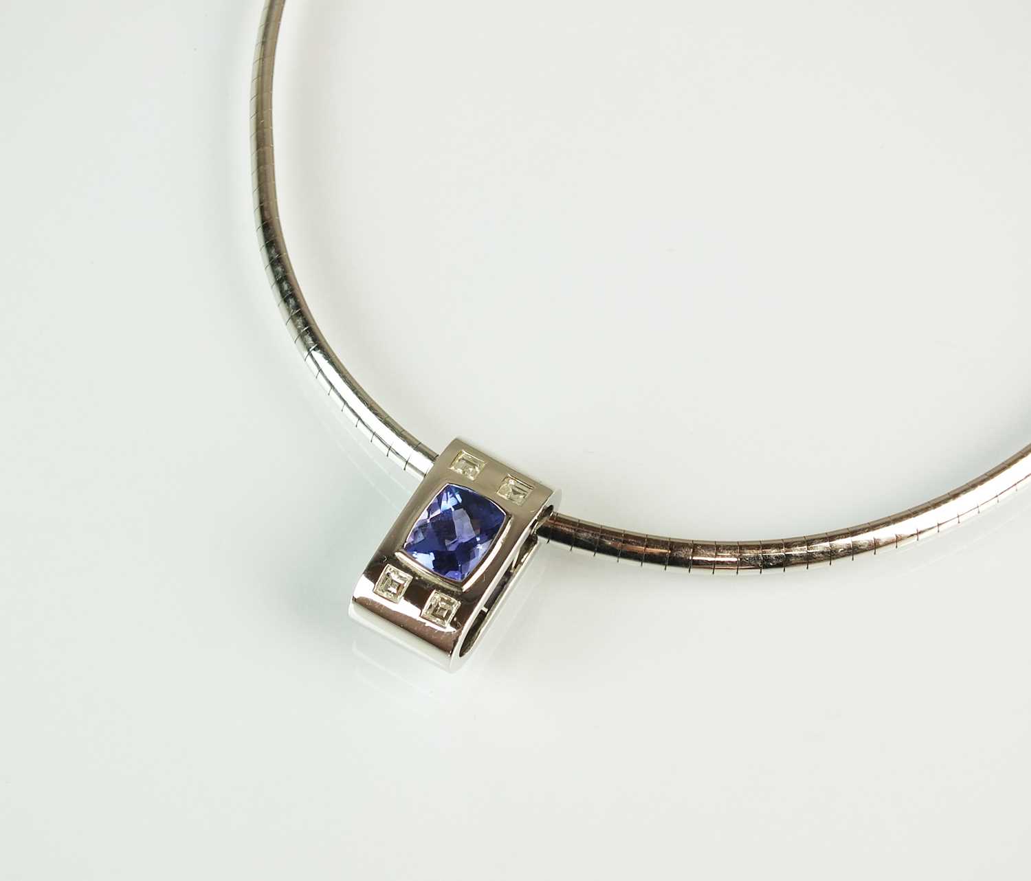 Lot 154 - A tanzanite and diamond pendant on chain