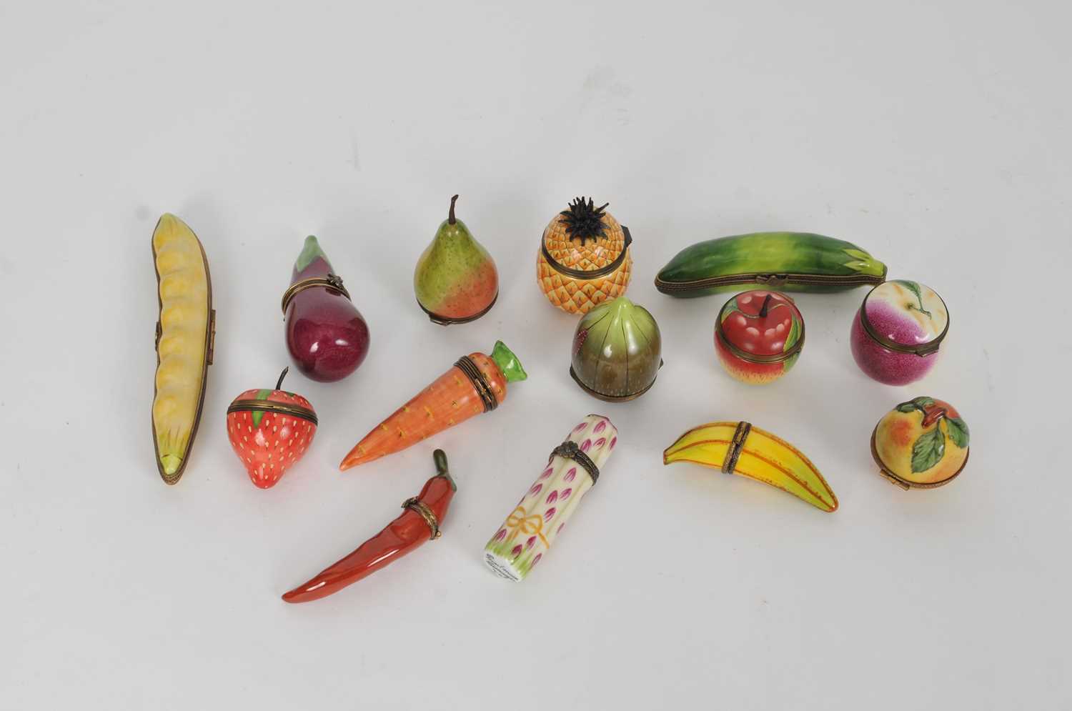 Lot 257 - A collection of Staffordshire and Limoges fruit-form enamel boxes