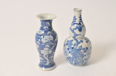 Lot 463 - A Chinese blue and white export gourd shaped vase and a prunus vase (2).