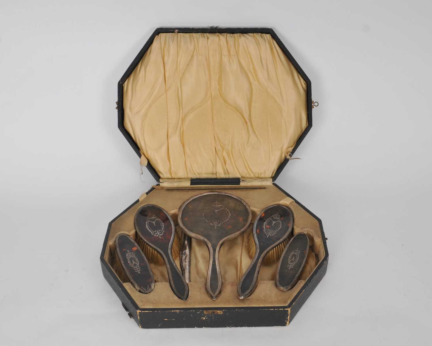 Lot 106 - A cased silver and tortoiseshell mounted dressing table set