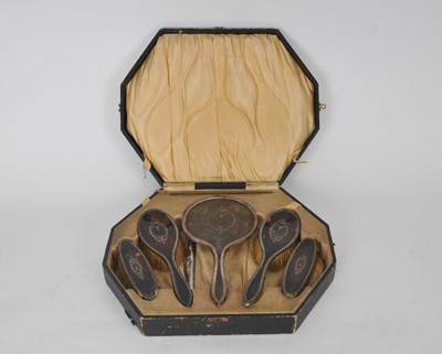 Lot 106 - A cased silver and tortoiseshell mounted dressing table set