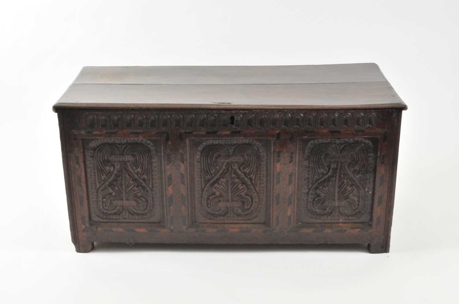 Lot 25 - A 17th century oak coffer, the twin panel top...