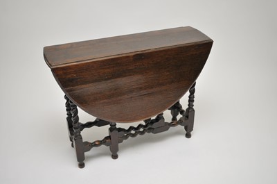 Lot 395 - A Restoration style oak gateleg table, the...
