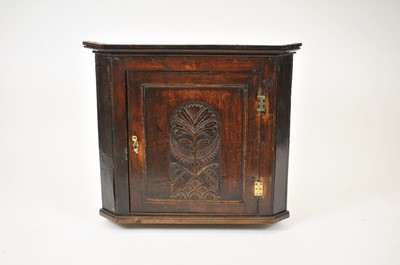 Lot 36 - An 18th century hanging corner cupboard, the...