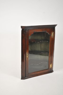 Lot 183 - An 18th century oak hanging corner cupboard,...