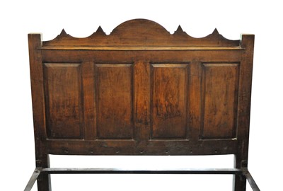 Lot 49 - An 18th century and later oak double bedhead...