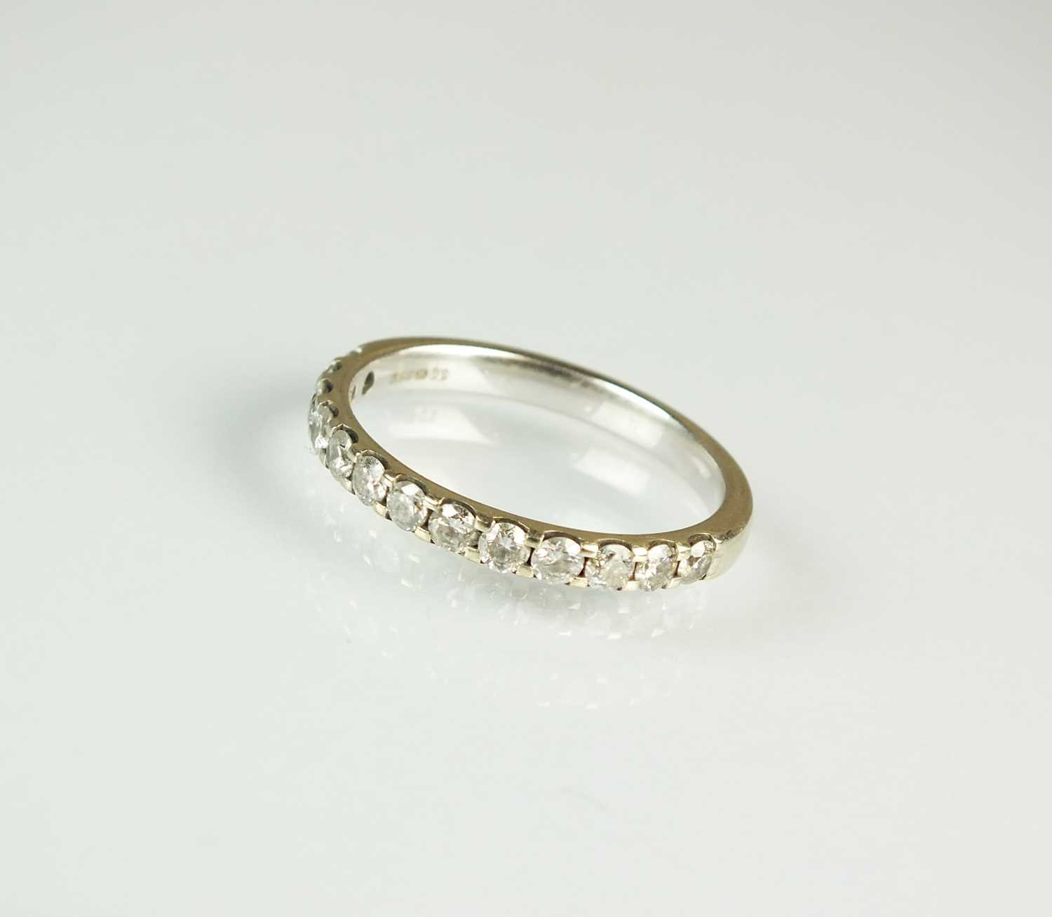 Lot 170 - A 9ct white gold diamond set half hoop eternity ring
