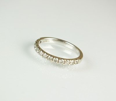 Lot 170 - A 9ct white gold diamond set half hoop eternity ring