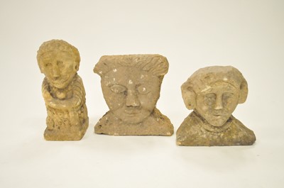 Lot 570 - A stylised carved limestone figure and two stylised limestone busts