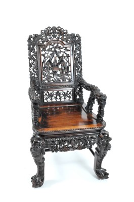 Lot 457 - A large late 19th / early 20th century Chinese carved hardwood armchair