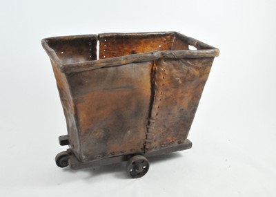 Lot 461 - An unusual rustic sewn hide laundry cart, on a...