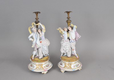 Lot 276 - A pair of French bisque candleholders and associated stands