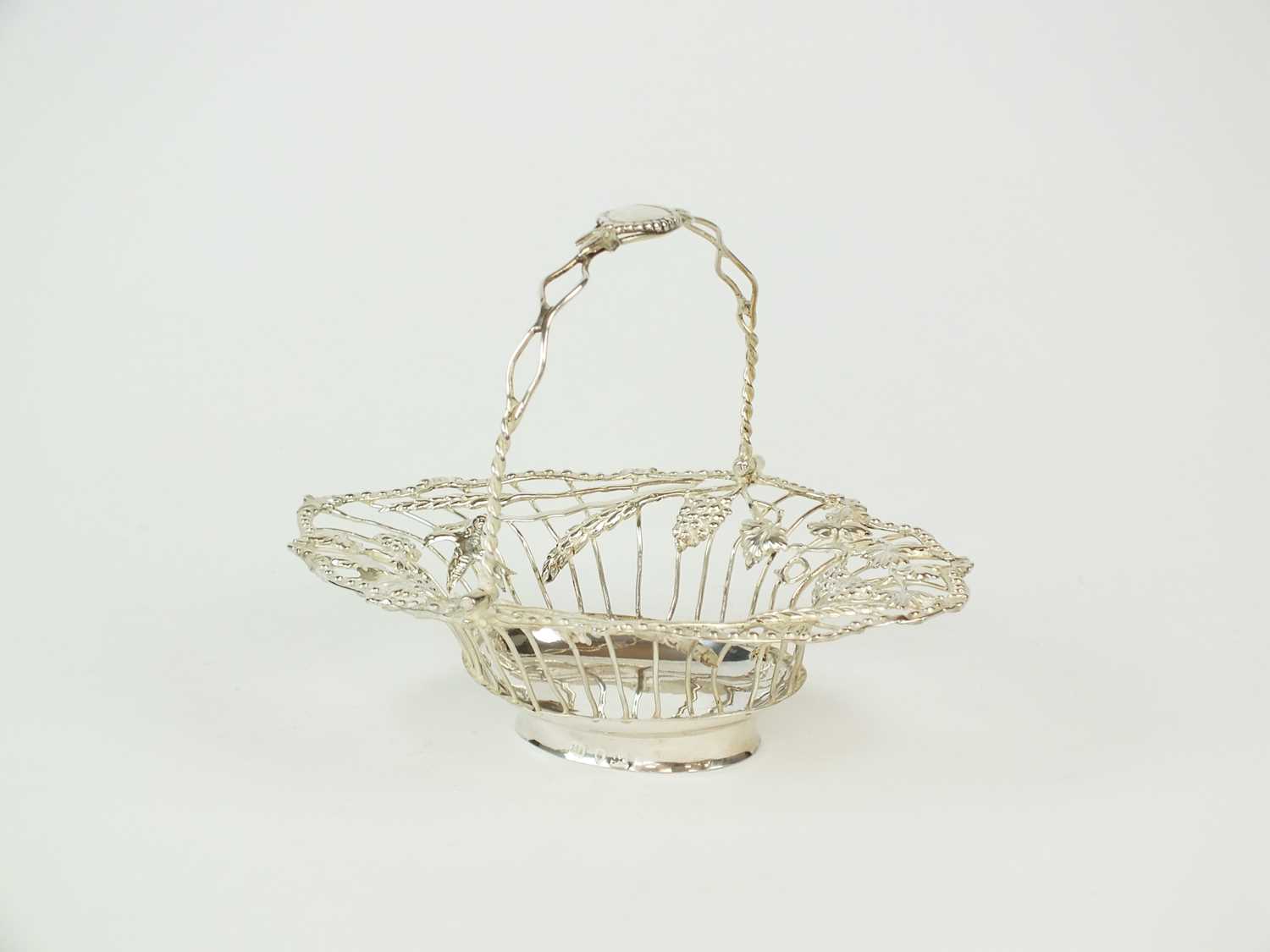 A George III silver swing handled sweetmeats basket
