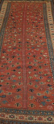 Lot 401 - An Eastern woven wool rug, the red field...