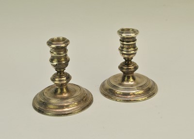 Lot 90 - A pair of short silver mounted candlesticks