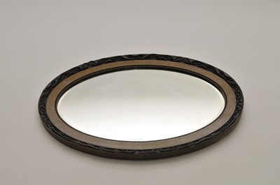 Lot 377 - An oval wall mirror with moulded frame and...