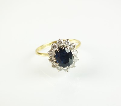 Lot 65 - An 18ct gold sapphire and diamond oval cluster ring