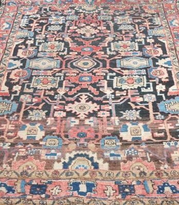 Lot 545 - An Eastern woven wool rug, with a dark field...