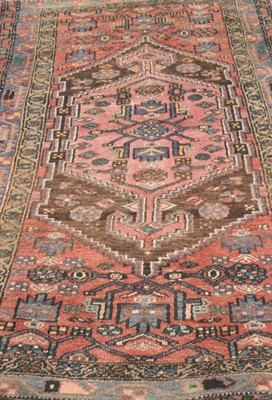 Lot 400 - A small Eastern woven wool rug, with central...