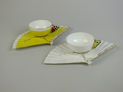 Lot 275 - A pair of John Mortlock for Samuel Moore butterfly-handled cups with fan saucers