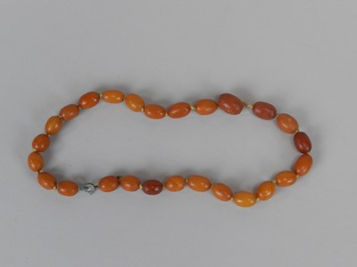 Lot 83 - A graduated amber bead necklace
