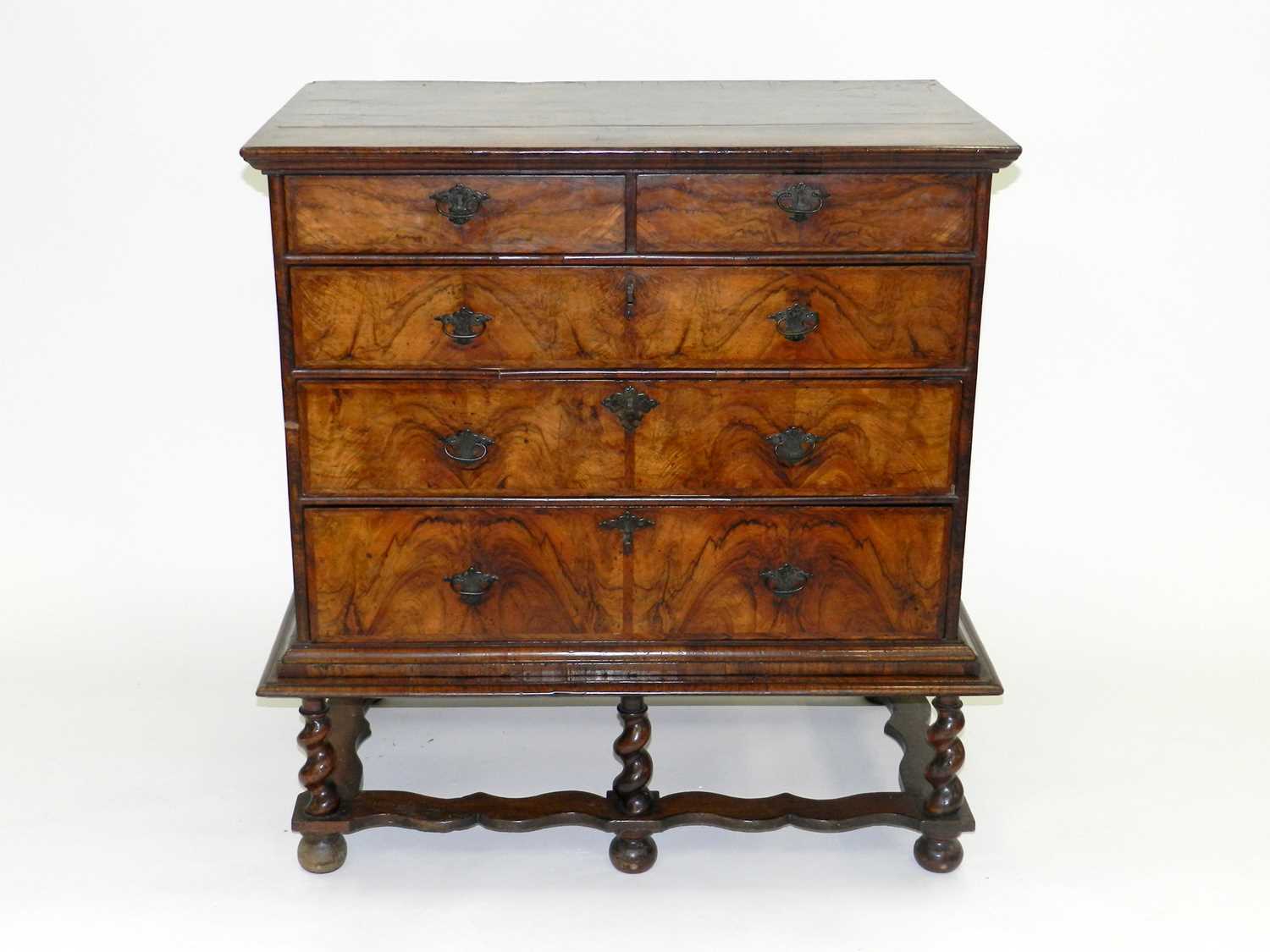 Lot 424 - An early 18th century walnut veneered chest,...