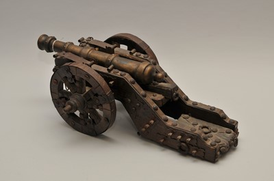 Lot 247 - A decorative model cannon, the cast metal gun...