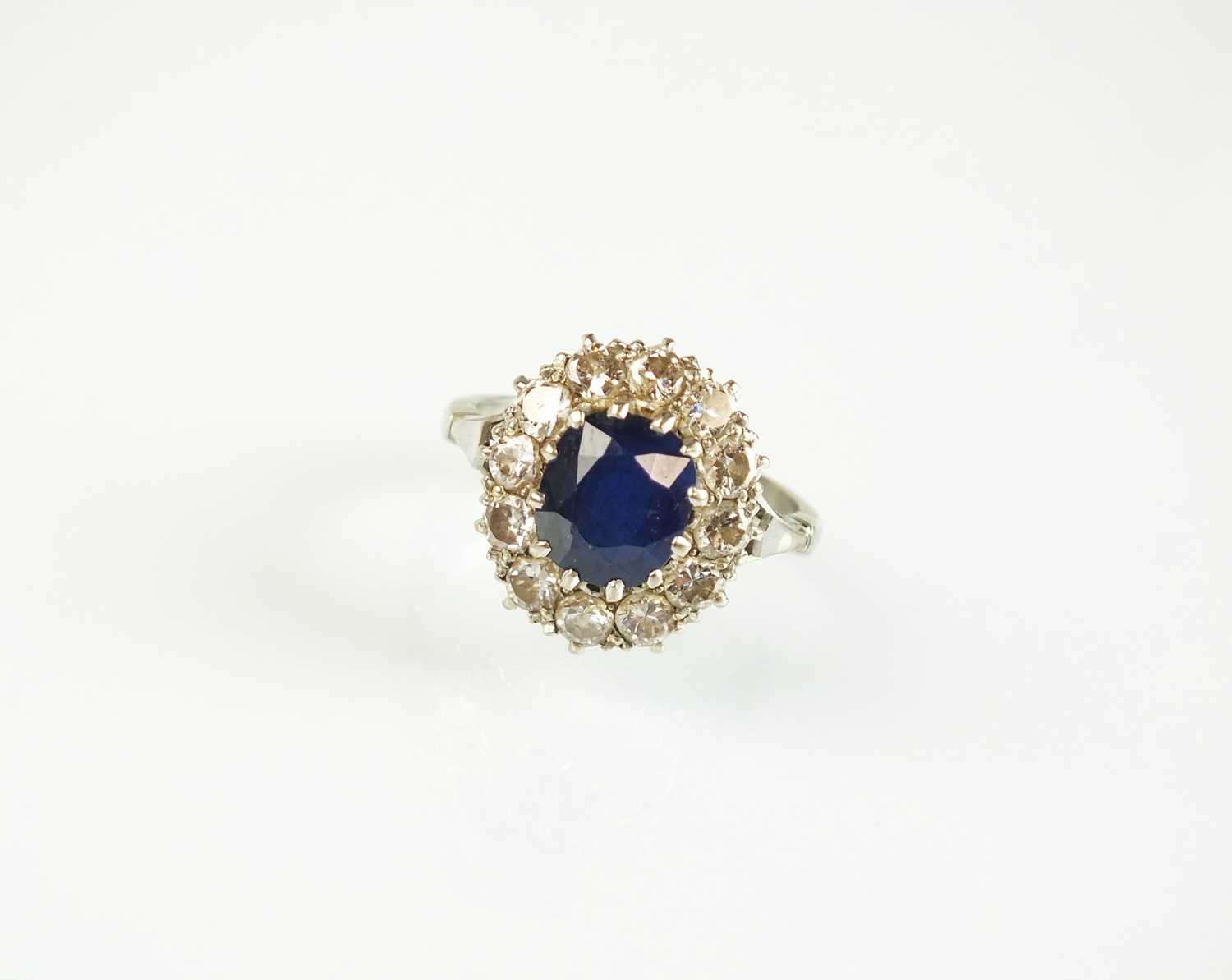 Lot 82 - A sapphire and diamond oval cluster ring