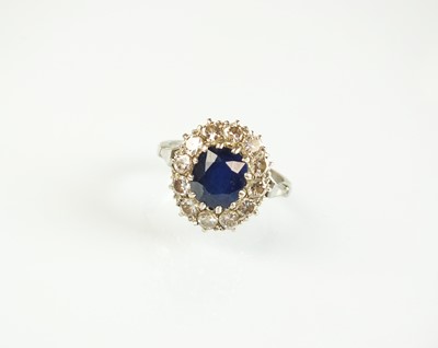 Lot 82 - A sapphire and diamond oval cluster ring