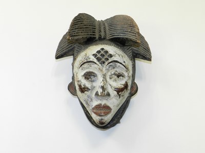 Lot 337 - A Punu carved and painted wood tribal mask,...