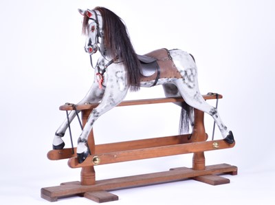 Lot 381 - A large painted wood rocking horse