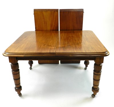 Lot 532 - An Edwardian walnut wind-out dining table, the...