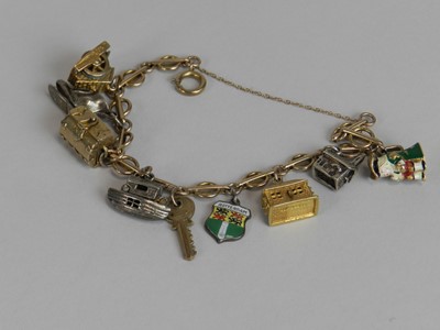 Lot 177 - A 9ct gold bracelet with attached 9ct gold and silver charms