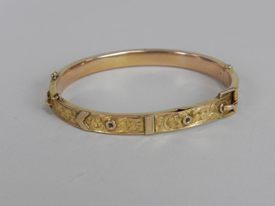 Lot 137 - A 9ct gold buckle bangle